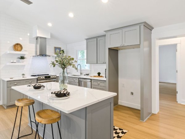 Kitchen with grey cabinets and warm laminate flooring